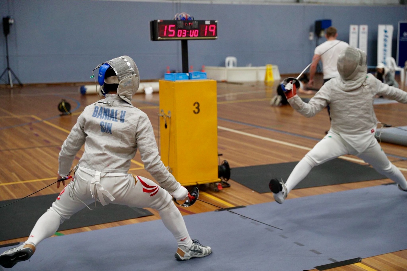Danial Haqim competing in a fencing bout for Singapore