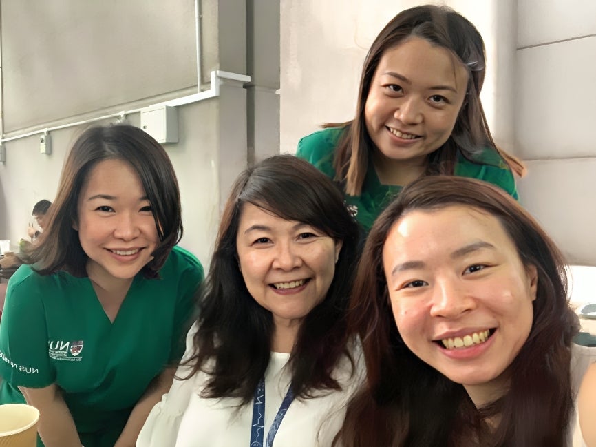 Dr Lim (left) with Celestine (standing, back) after a lab session.