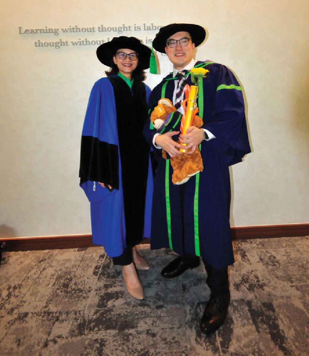 Dr Tan (right) at his PhD conferment ceremony with Dr Lim (left).