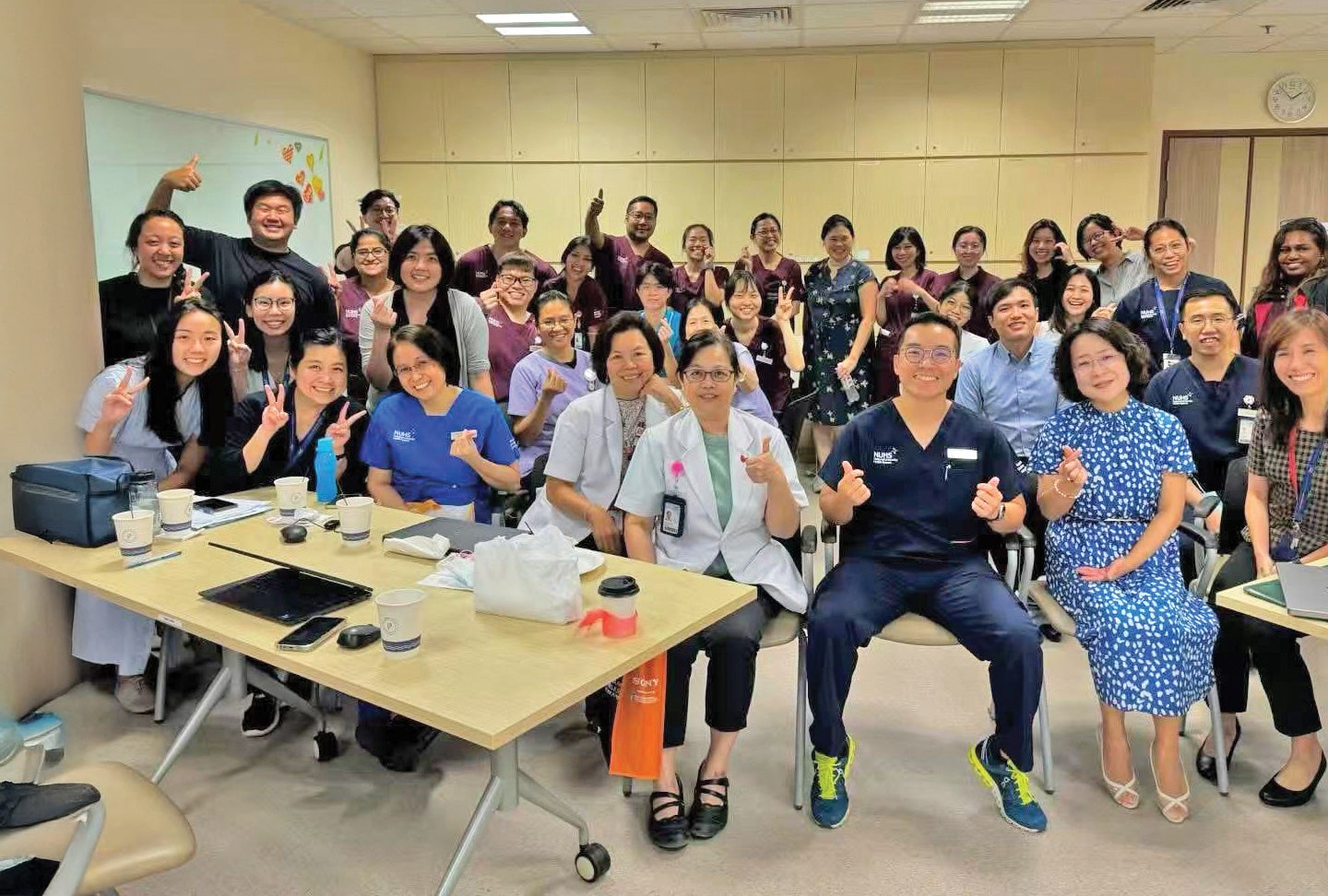 Prof Wang (front row, third from right) and her NUHCS collaborators.