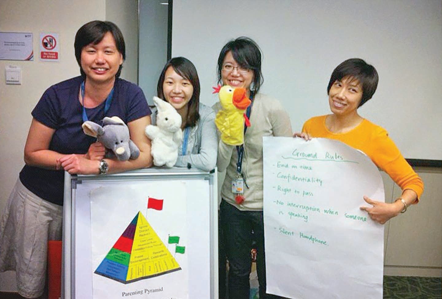 Dr Jiang (second from right) conducting a parenting workshop with her former clinical colleagues.