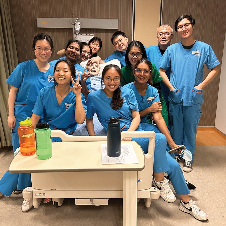 Dr Chua with nurses near patient bed