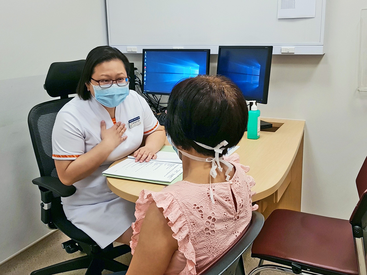 Alice Chua consulting a patient