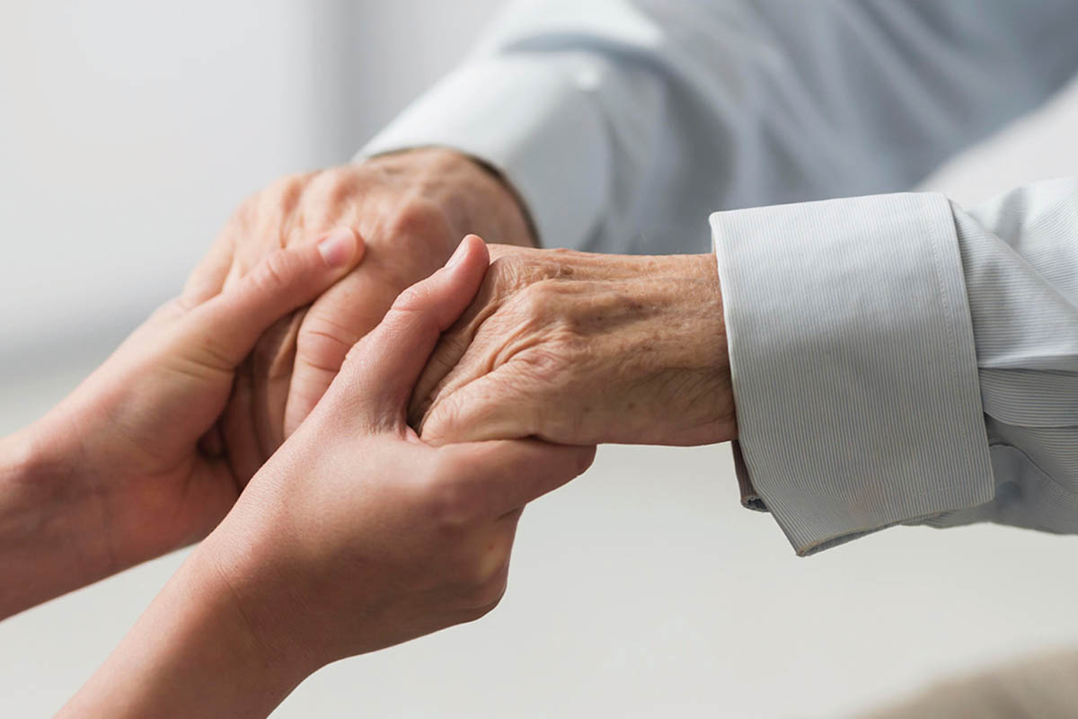 Photo of nurse hands helping elderly hands