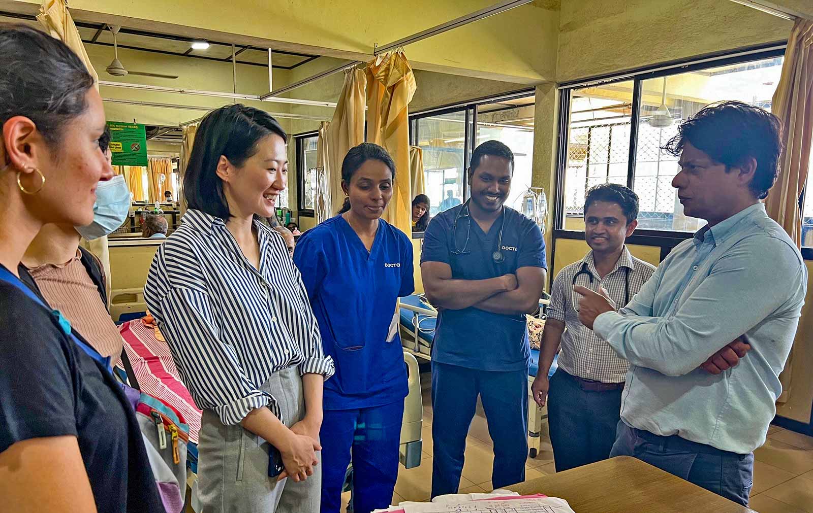 Photo of group of doctos and nurses at patient bedside at Sri Lanka.