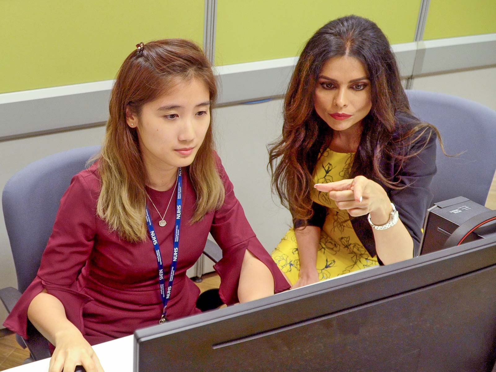 A/Prof Shefaly Shorey (right) and research team member Debby Ng (left), discussing the results from studies conducted on the Supportive Parenting App.