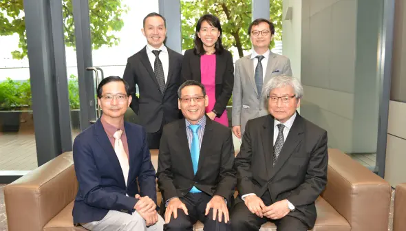 Multiple researchers working together in a lab portraying NUS Medicine Research