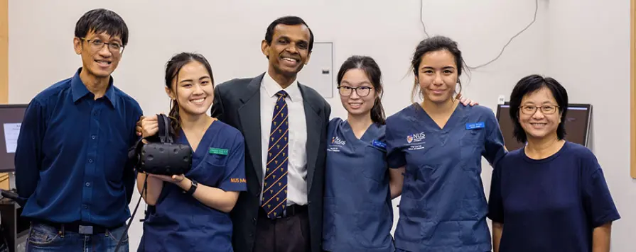 Medical students in Singapore holding a VR device in a campus lab