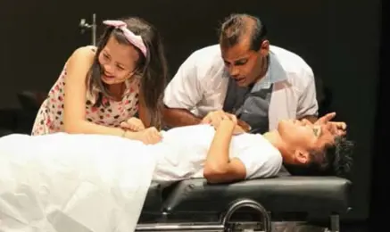 Medical students practising clinical examination skills on a patient as part of NUS Medicine campus life