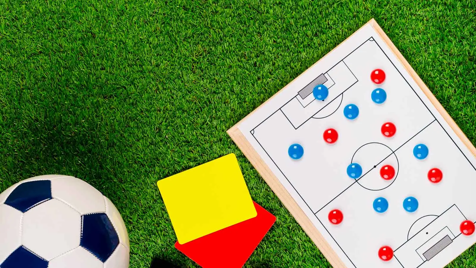 A soccer ball, coach whistle, referee cards and clipboards.