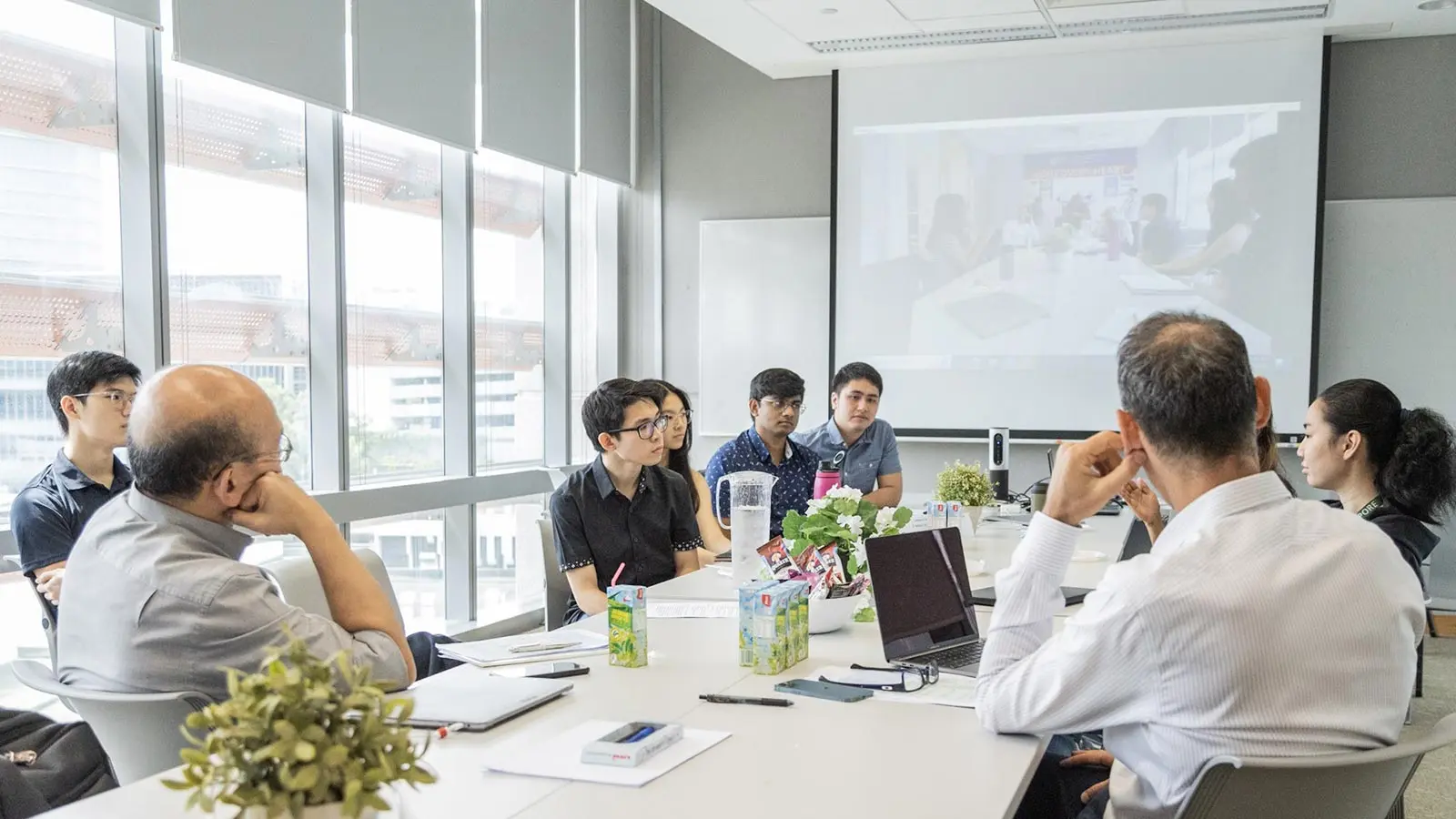 CVMD trainees together at a meeting room, in active discussion with leading professors in cardiovascular and metabolic research.