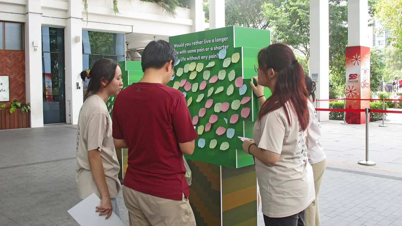 Participants at PHA exhibition answering questions designed to encourage members of the public to think about their values, priorities and needs towards the end of life.