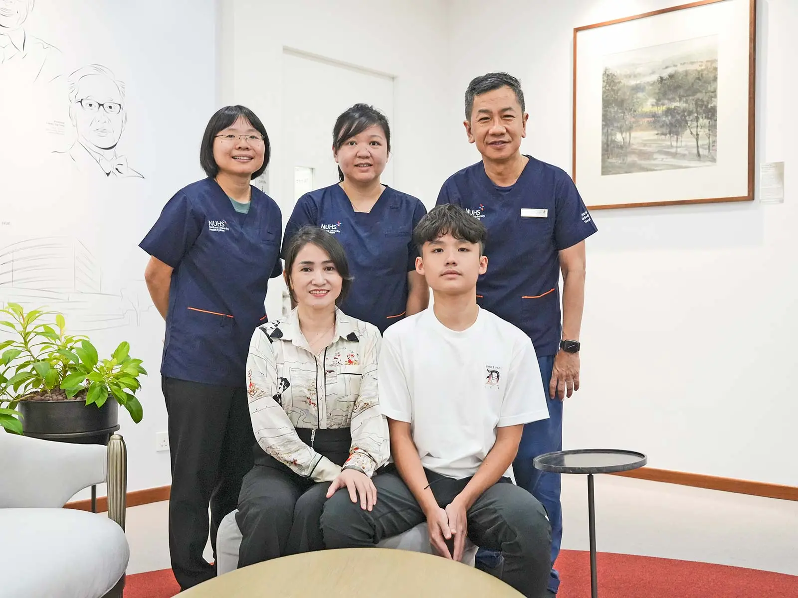 (Clockwise from left) Dr Esther Chan, Dr Bernice Oh and Prof Allen Yeoh, patient Viet Tai and his mother, Mdm Nguyen. Credit: National University Health System