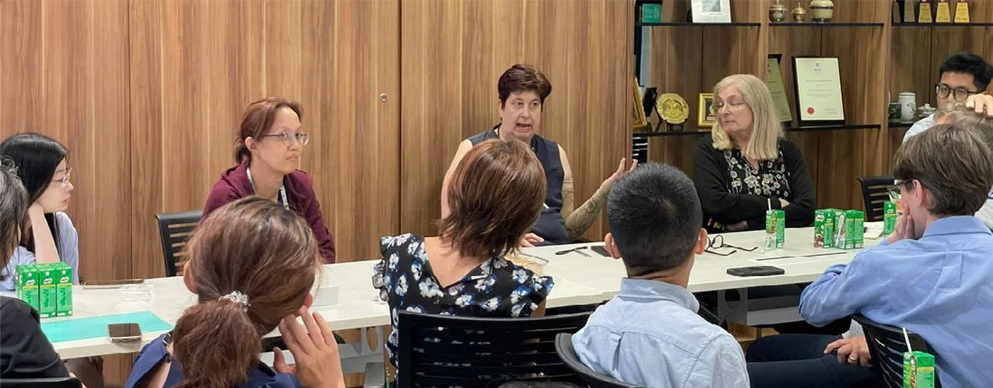 Dr Laurie J. Goldsmith seated in the middle with other participants seated around her.