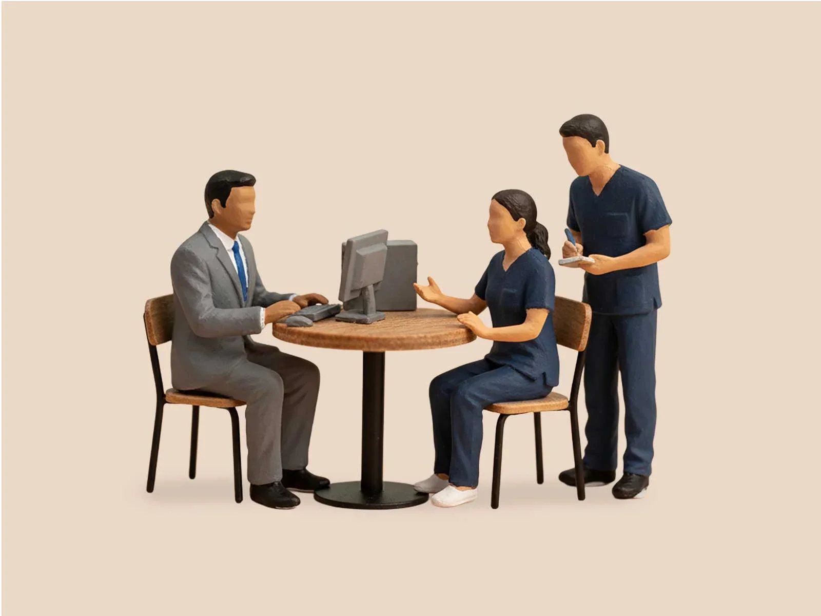 Computer-generated graphic of 3 miniatures of doctors and nurses on a wooden round table.