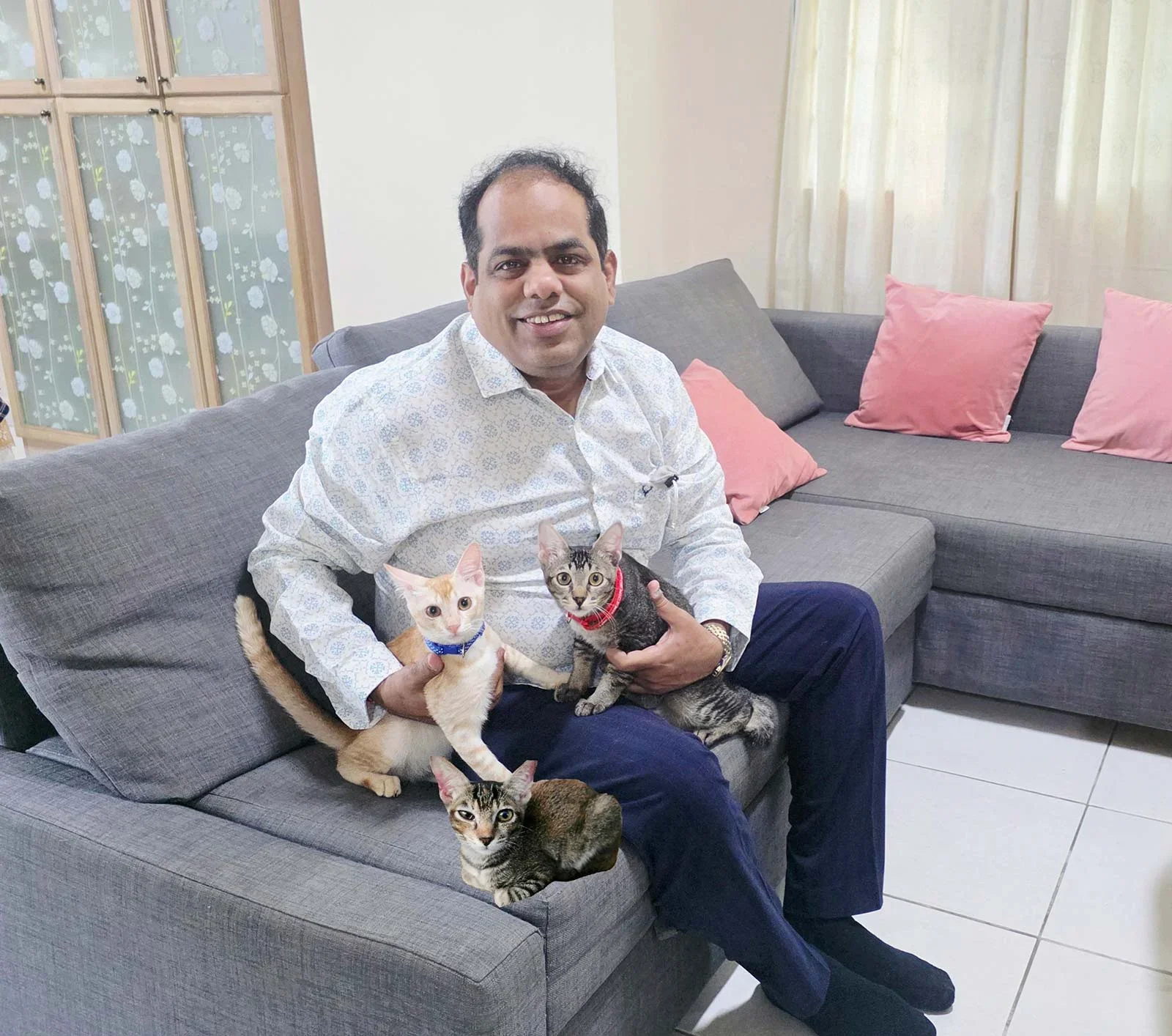 Associate Professor Srinivasan Dinesh Kumar and 3 cats on a sofa.
