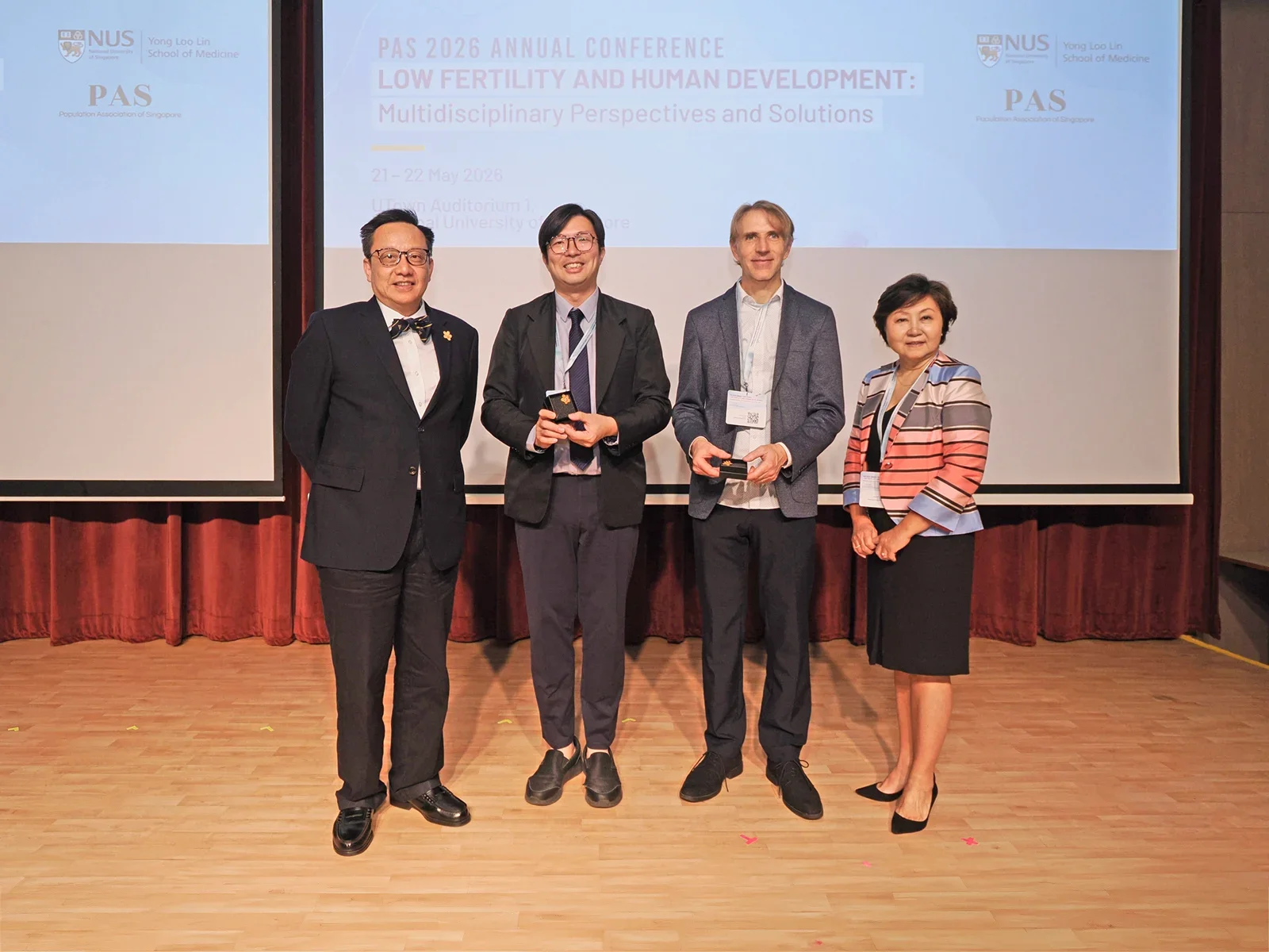 Dean Professor Chong Yap Seng on the left, and three other professors/individuals standing to the right of him.